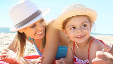 Family laying on the beach together