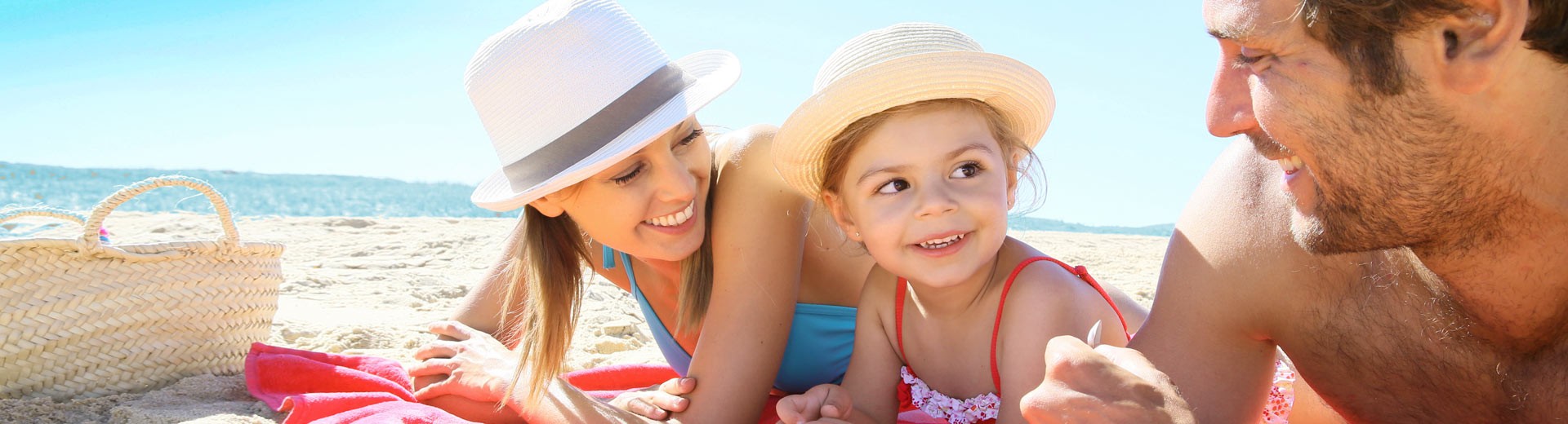 Family laying on the beach together