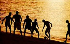 Men on Beach Playing Football